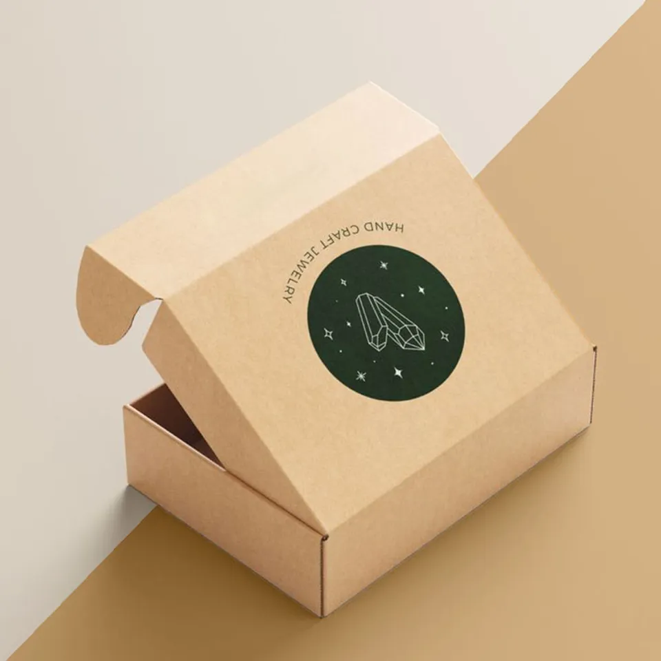 Brown Kraft Mailer Boxes: Kraft mailer with rolled side ears and a single dark circular logo printed on the lid