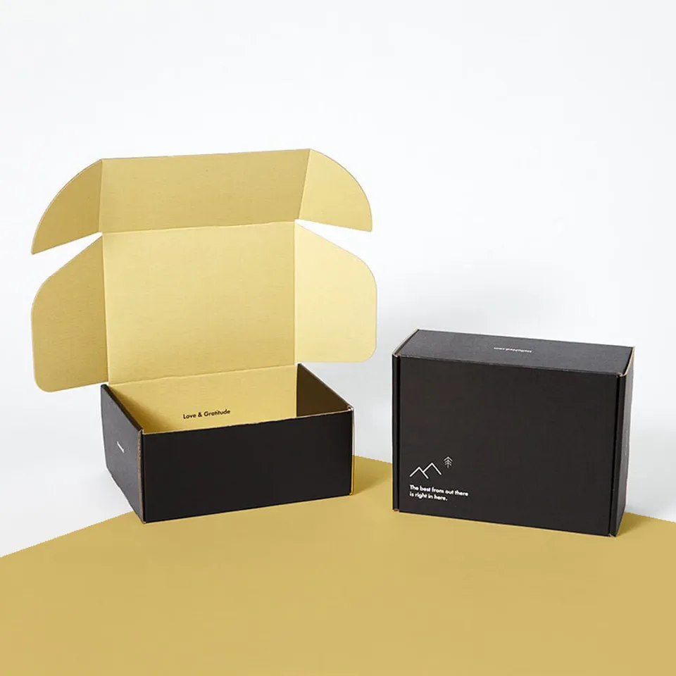 Ear Lock Mailer Boxes: Black box open to a pale yellow interior beside a closed black box with small white print