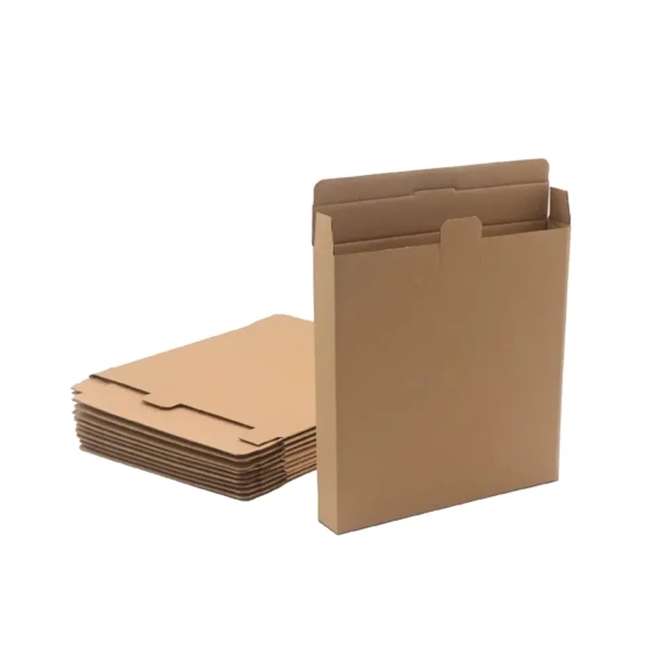 End Open Mailer Boxes: Kraft end loading box with its top flap and tab open, beside a stack of flat blanks