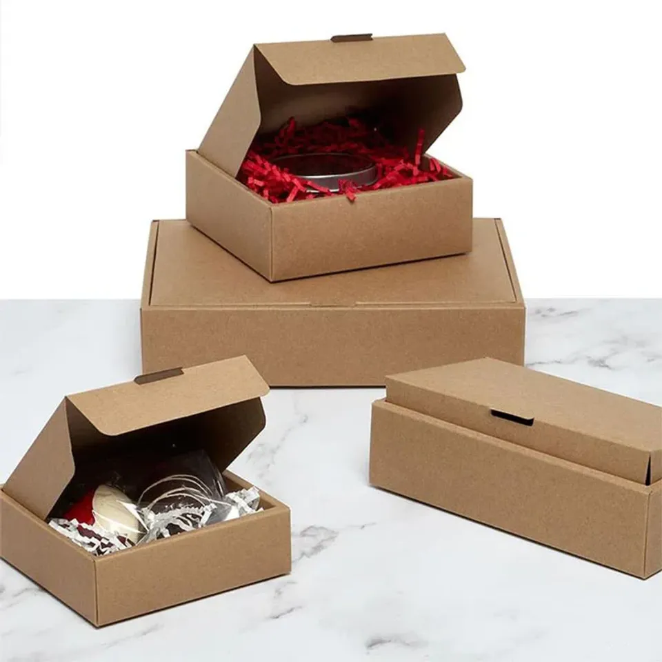 Fragile Goods Mailer Boxes: Kraft mailers in three sizes, two open with red and white paper shred around the contents