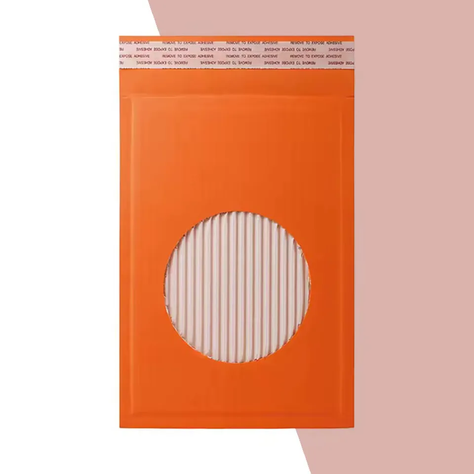 Paper Padded Mailers: Orange padded mailer with a round cut-out showing a ribbed paper lining underneath