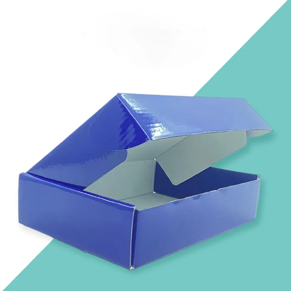 Subscription Box Mailers: Glossy royal blue mailer with a plain white inside, lid lifted on its roll-over front