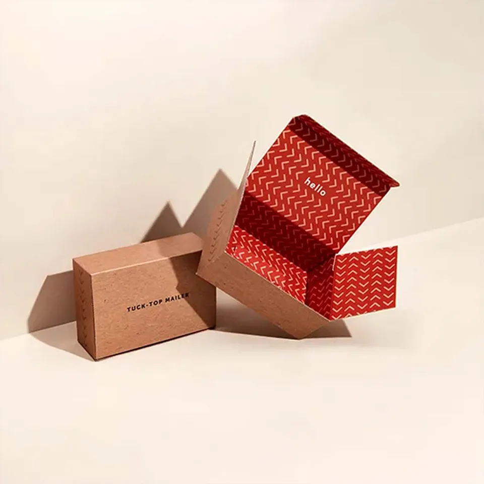 Tuck Top Mailer Boxes: Two kraft tuck top boxes, one closed, one open to show a red chevron print inside the lid